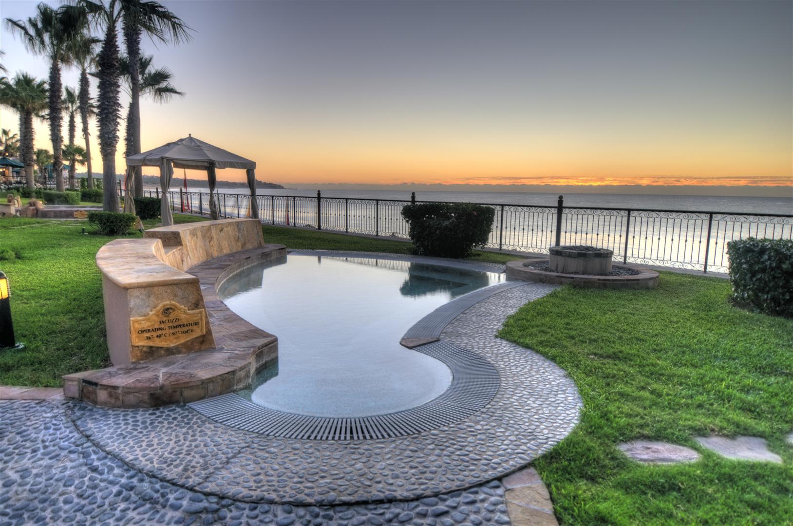 Couple relaxing poolside at a luxury Cabo San Lucas resort